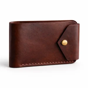 Front view of a hand-stitched leather bifold showing two card slots with thumb-slide cutouts by Indus Hide