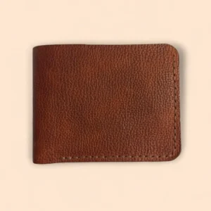 Front view of The Stag by Indus Hide, a handmade reddish brown pebble-grain leather bifold wallet with tan hand-saddle stitching.
